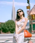 A bride on Powell Street with the Transamerica Pyramid behind