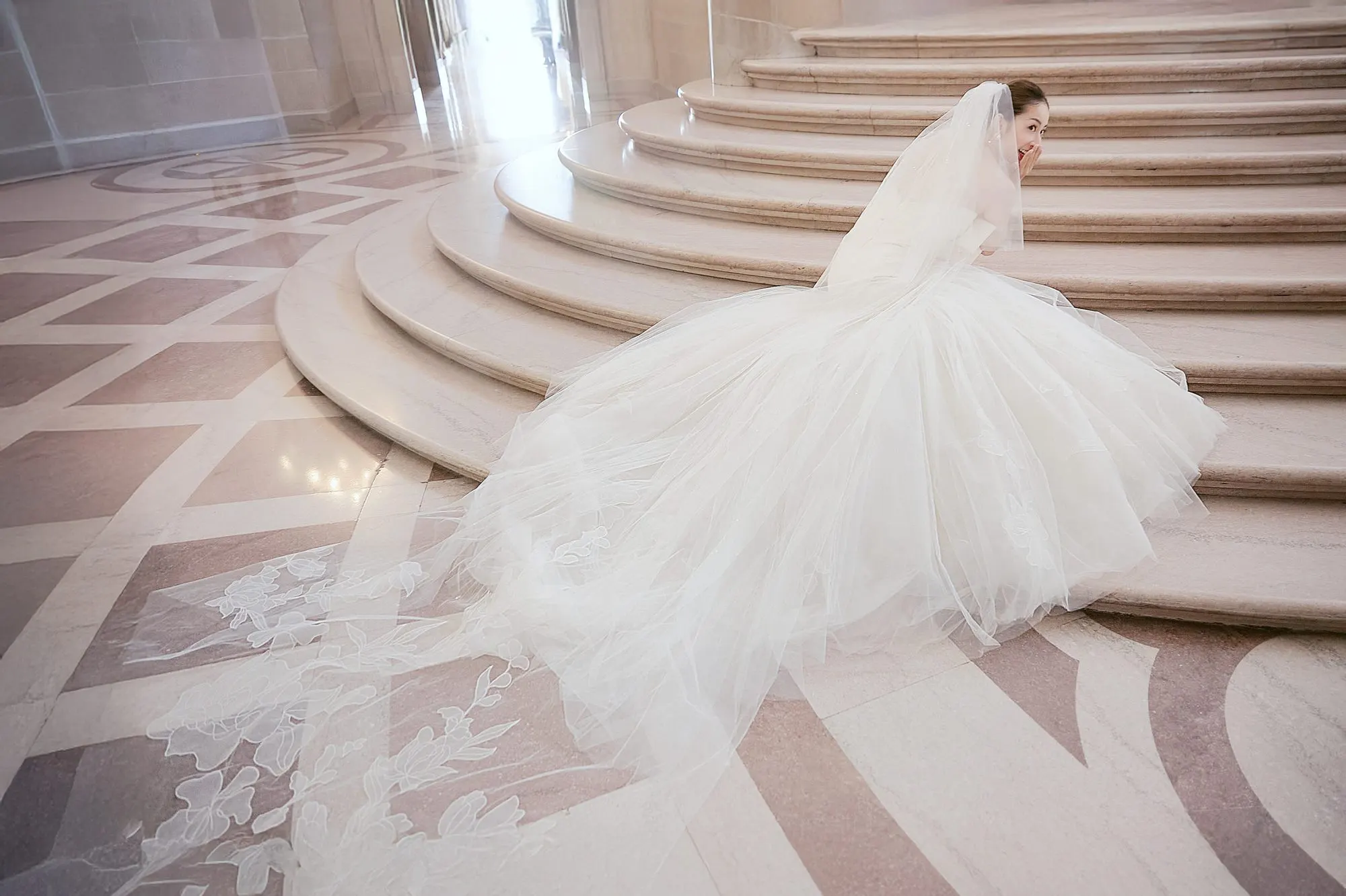 Bride in a bow-front gown at City Hall, frame 15 of 24