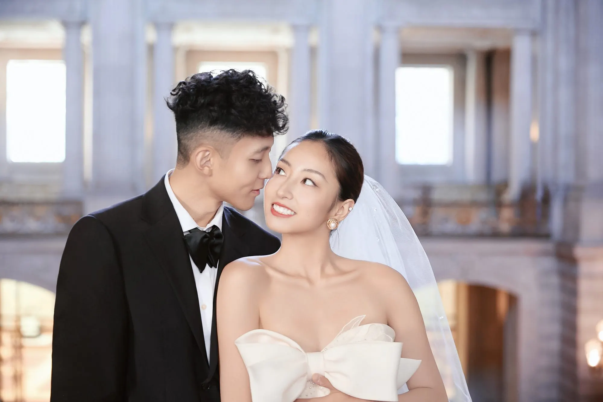 Bride in a bow-front gown at City Hall, frame 20 of 24