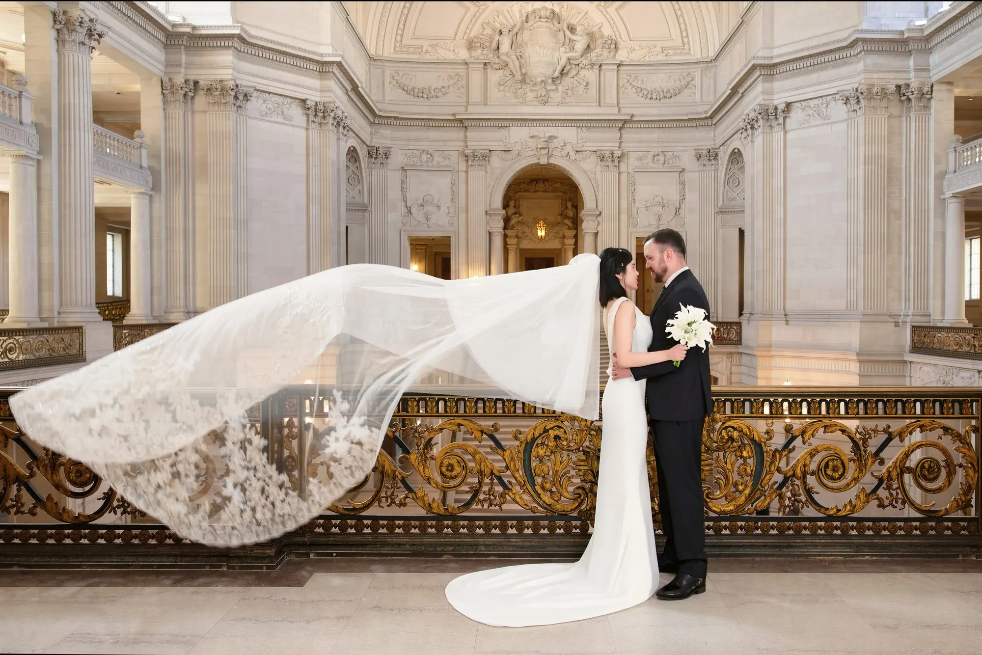 City Hall wedding with calla lilies and a long lace veil, frame 9 of 25