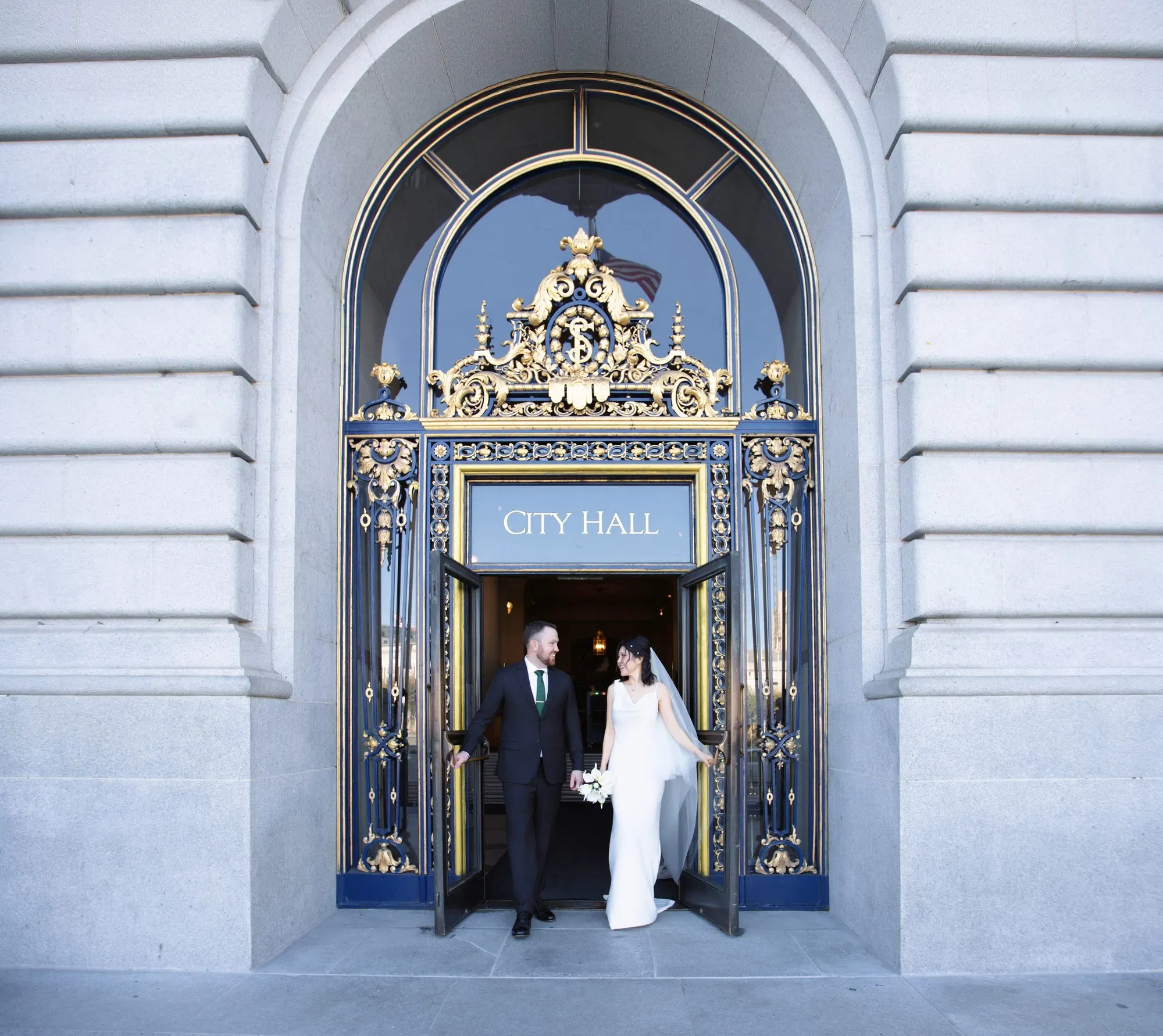 City Hall wedding with calla lilies and a long lace veil, frame 23 of 25