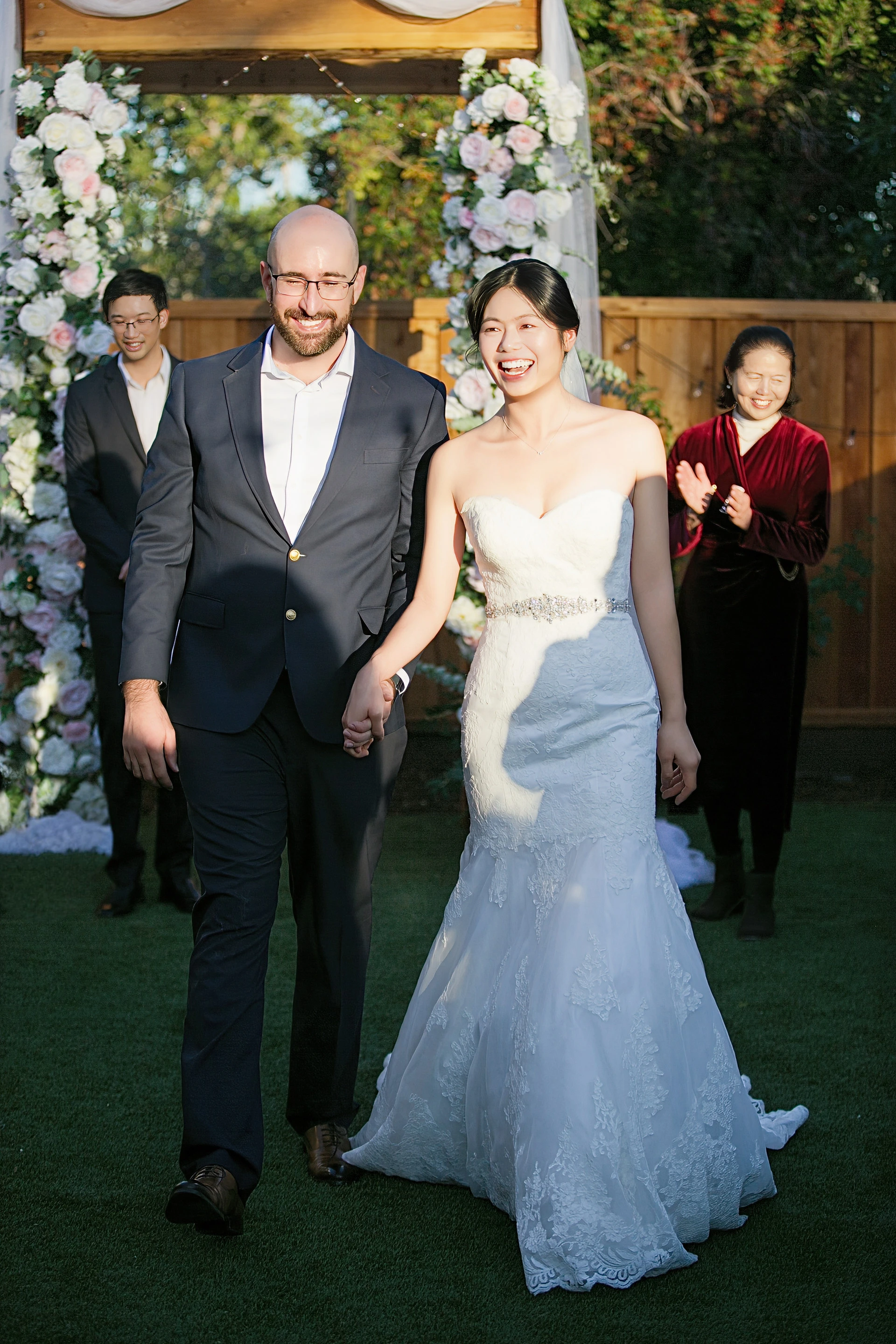 Garden wedding ceremony under a flower arch