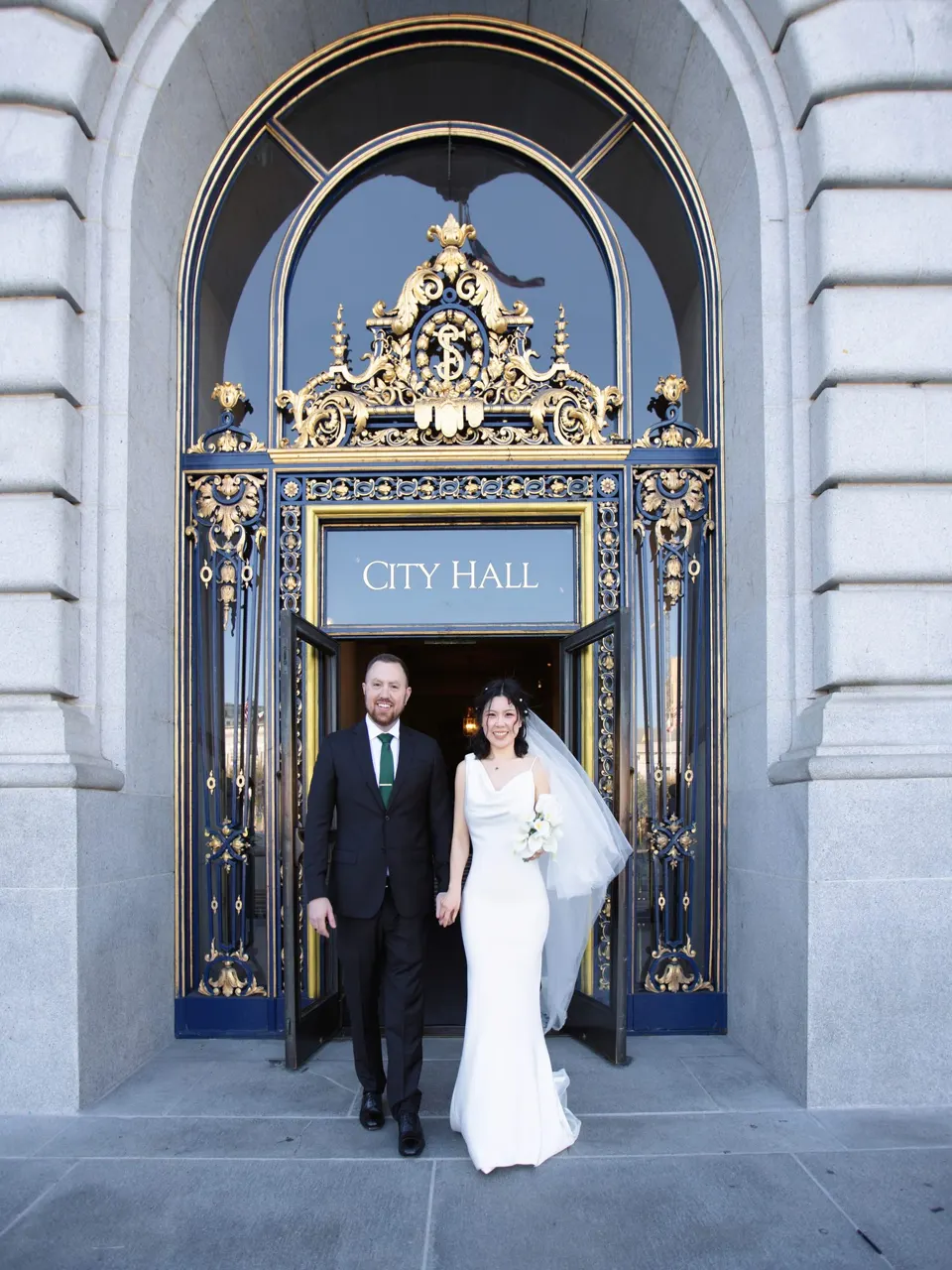 City Hall wedding with calla lilies and a long lace veil, frame 24 of 25