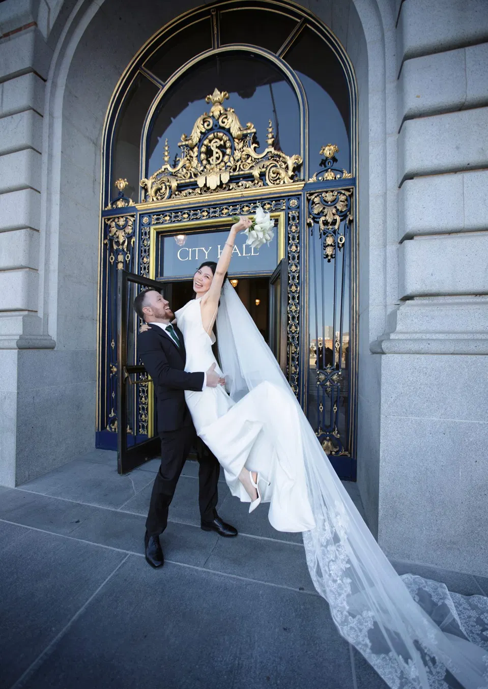City Hall wedding with calla lilies and a long lace veil, frame 22 of 25