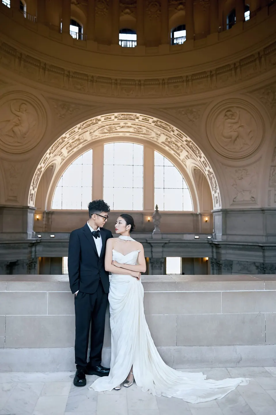 Bride in a bow-front gown at City Hall, frame 9 of 24