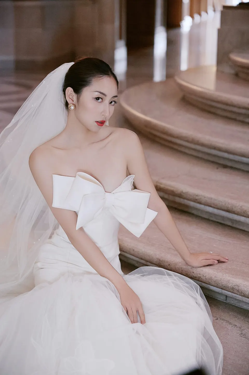 Bride in a bow-front gown at City Hall, frame 14 of 24
