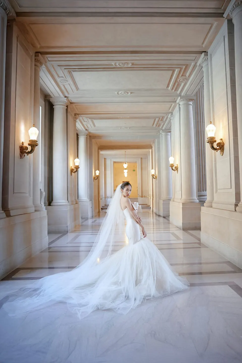 Bride in a bow-front gown at City Hall, frame 16 of 24