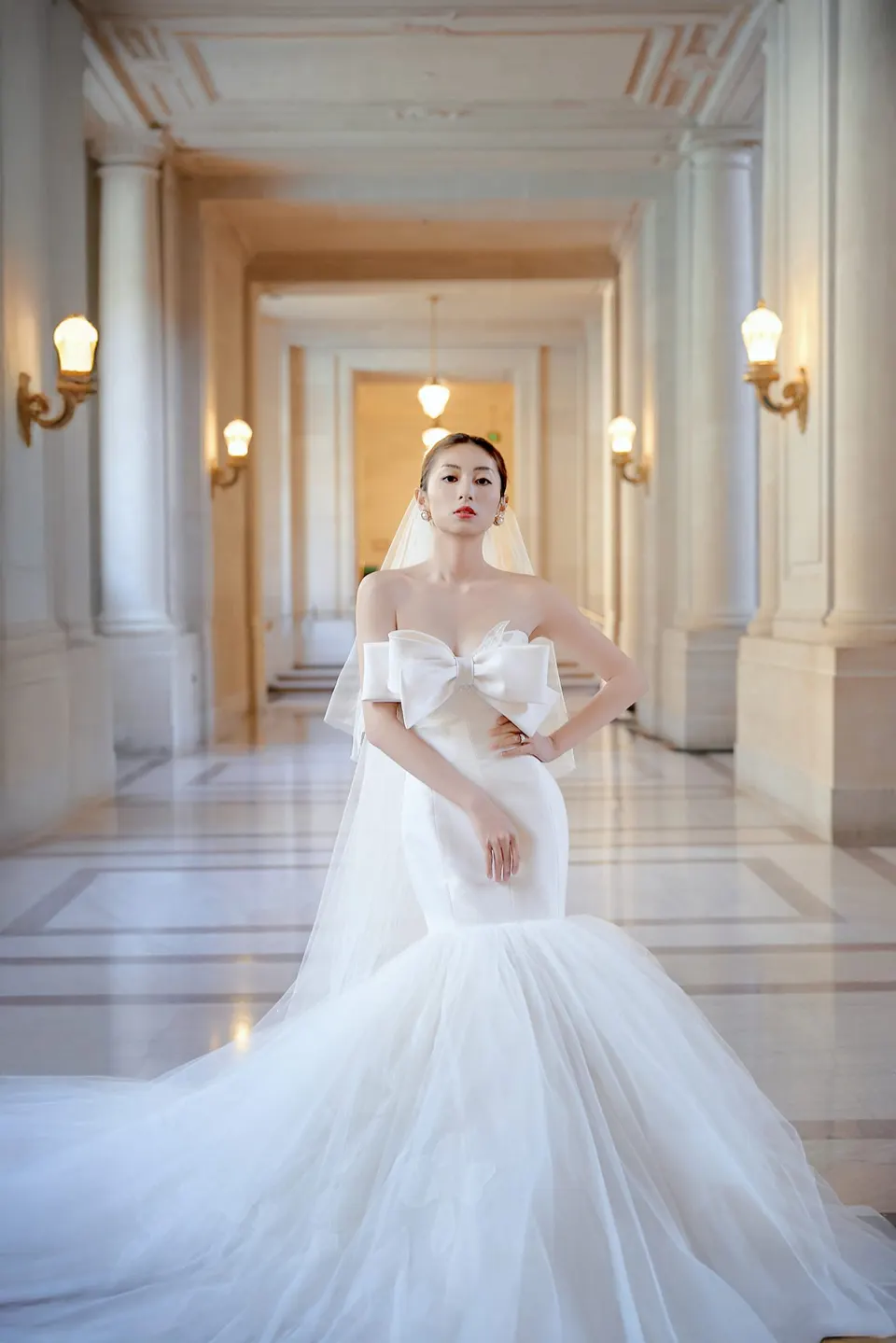Bride in a bow-front gown at City Hall, frame 17 of 24