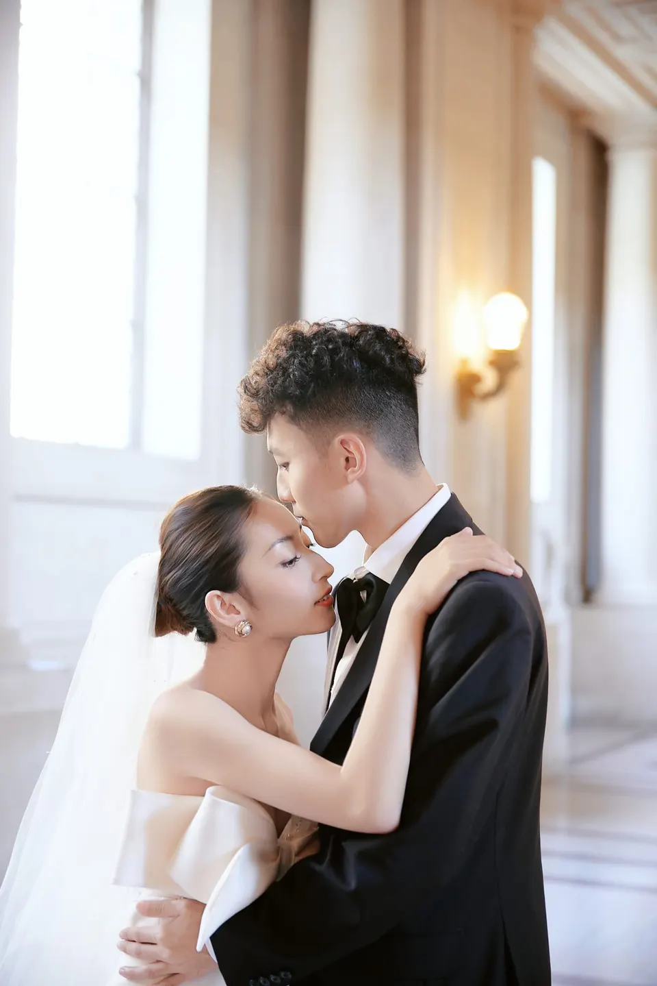 Bride in a bow-front gown at City Hall, frame 18 of 24