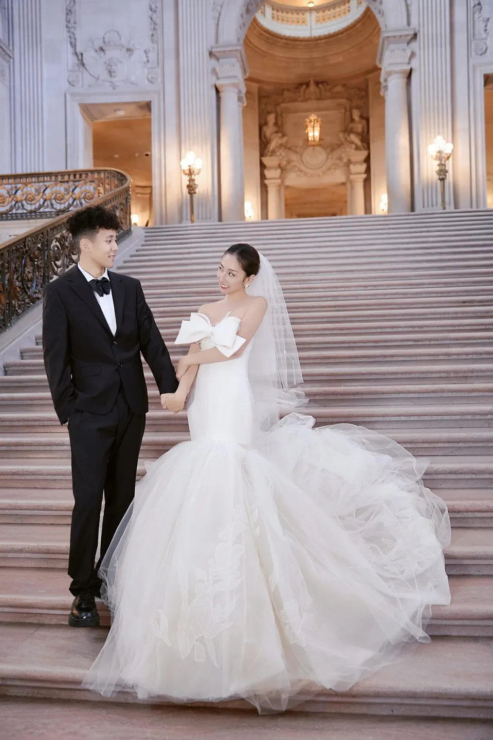 Bride in a bow-front gown at City Hall, frame 24 of 24