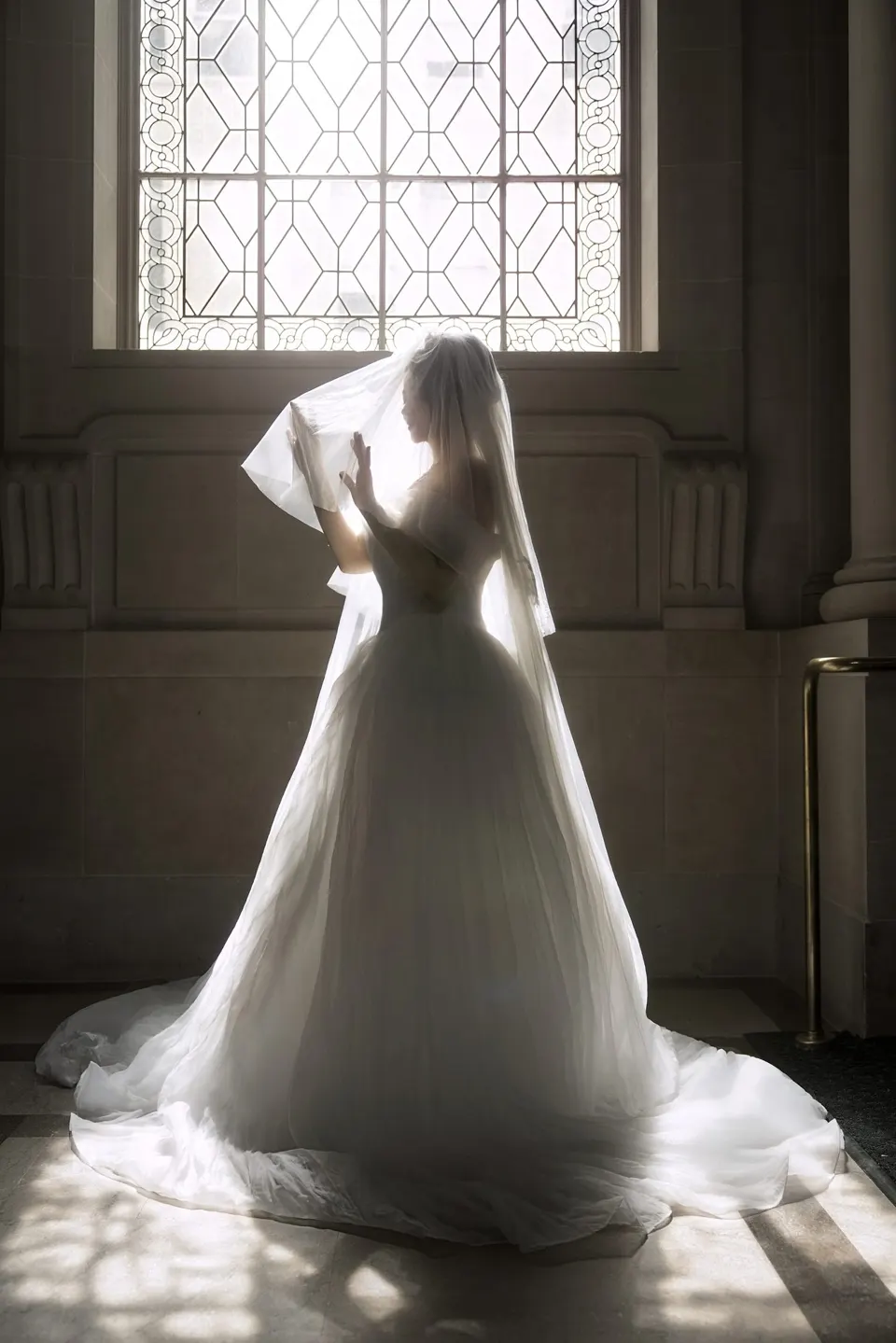 Bride with a long train at City Hall, frame 3 of 9