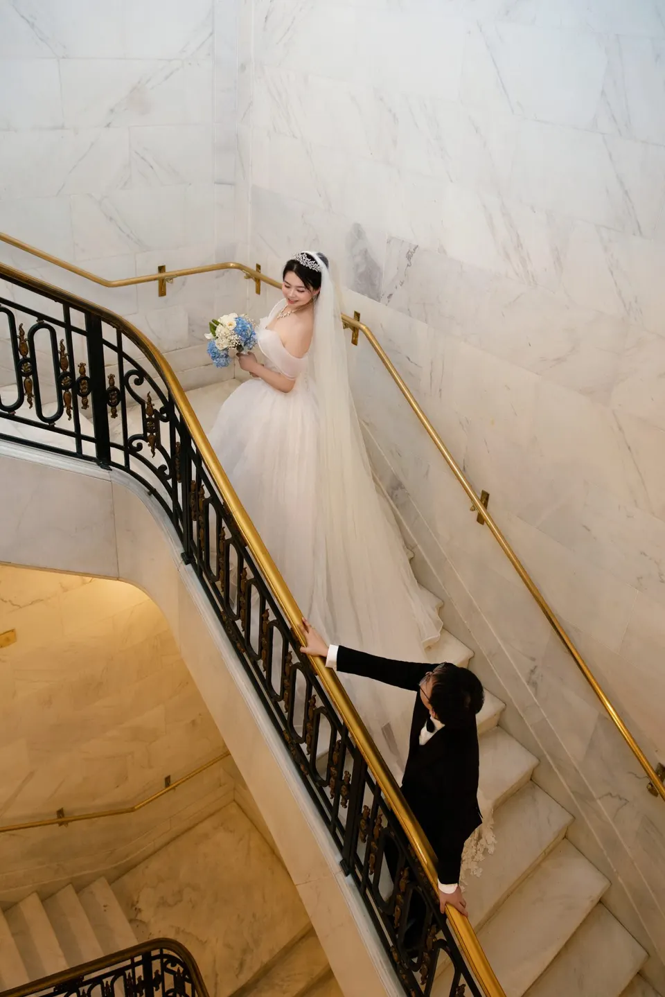 Bride with a long train at City Hall, frame 5 of 9