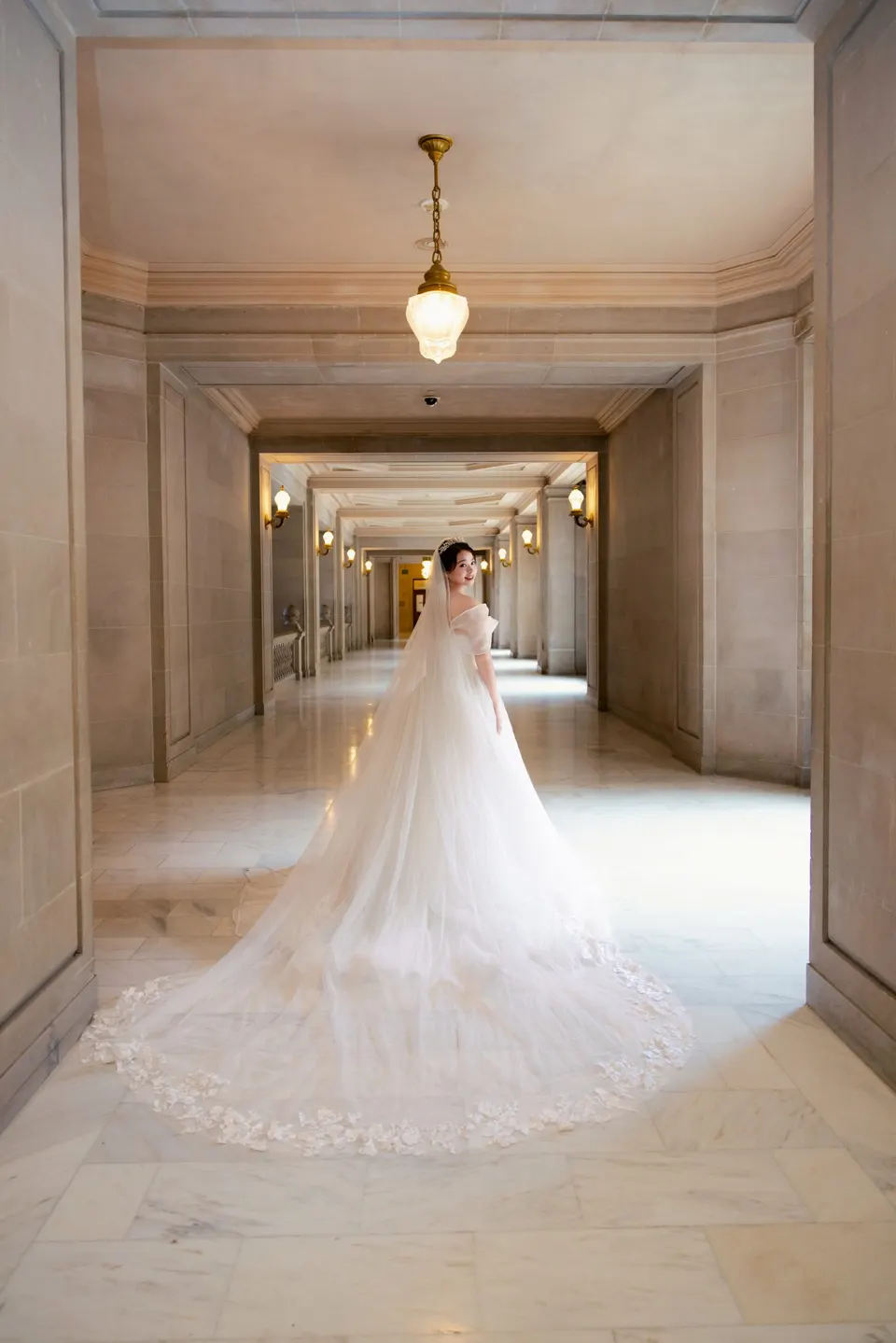 Bride with a long train at City Hall, frame 6 of 9