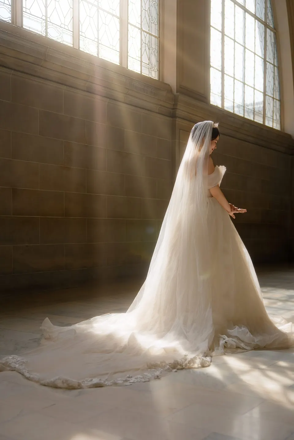 Bride with a long train at City Hall, frame 7 of 9