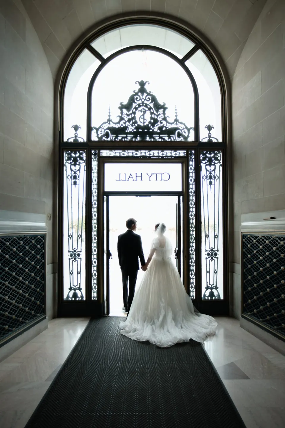 Bride with a long train at City Hall, frame 9 of 9