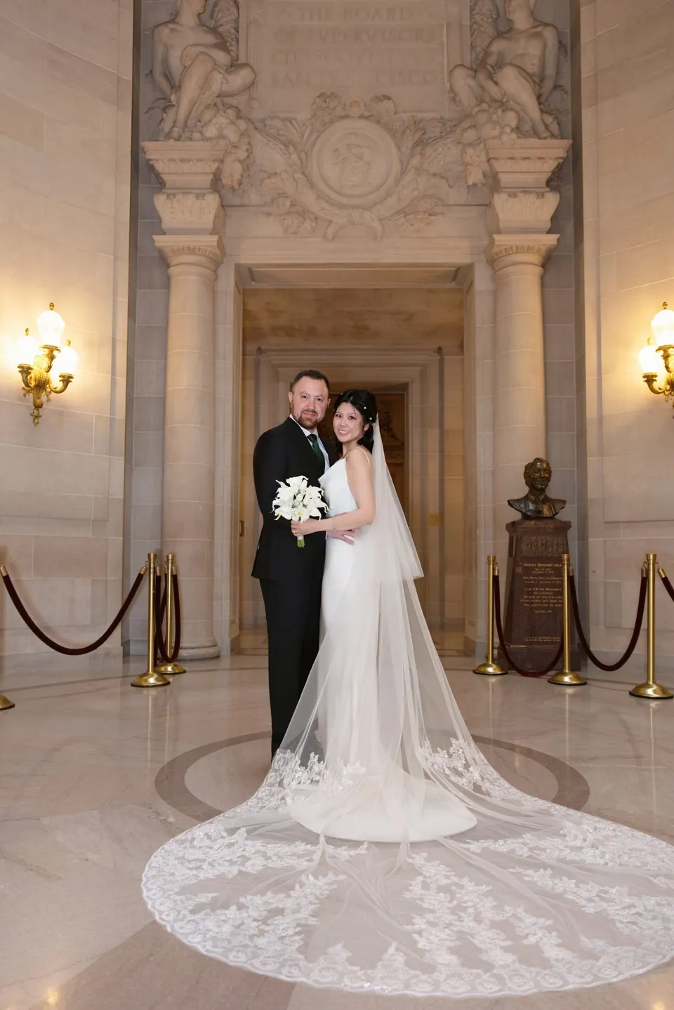 City Hall wedding with calla lilies and a long lace veil, frame 6 of 25