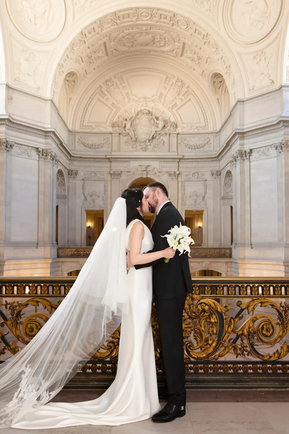 City Hall wedding with calla lilies and a long lace veil, frame 8 of 25