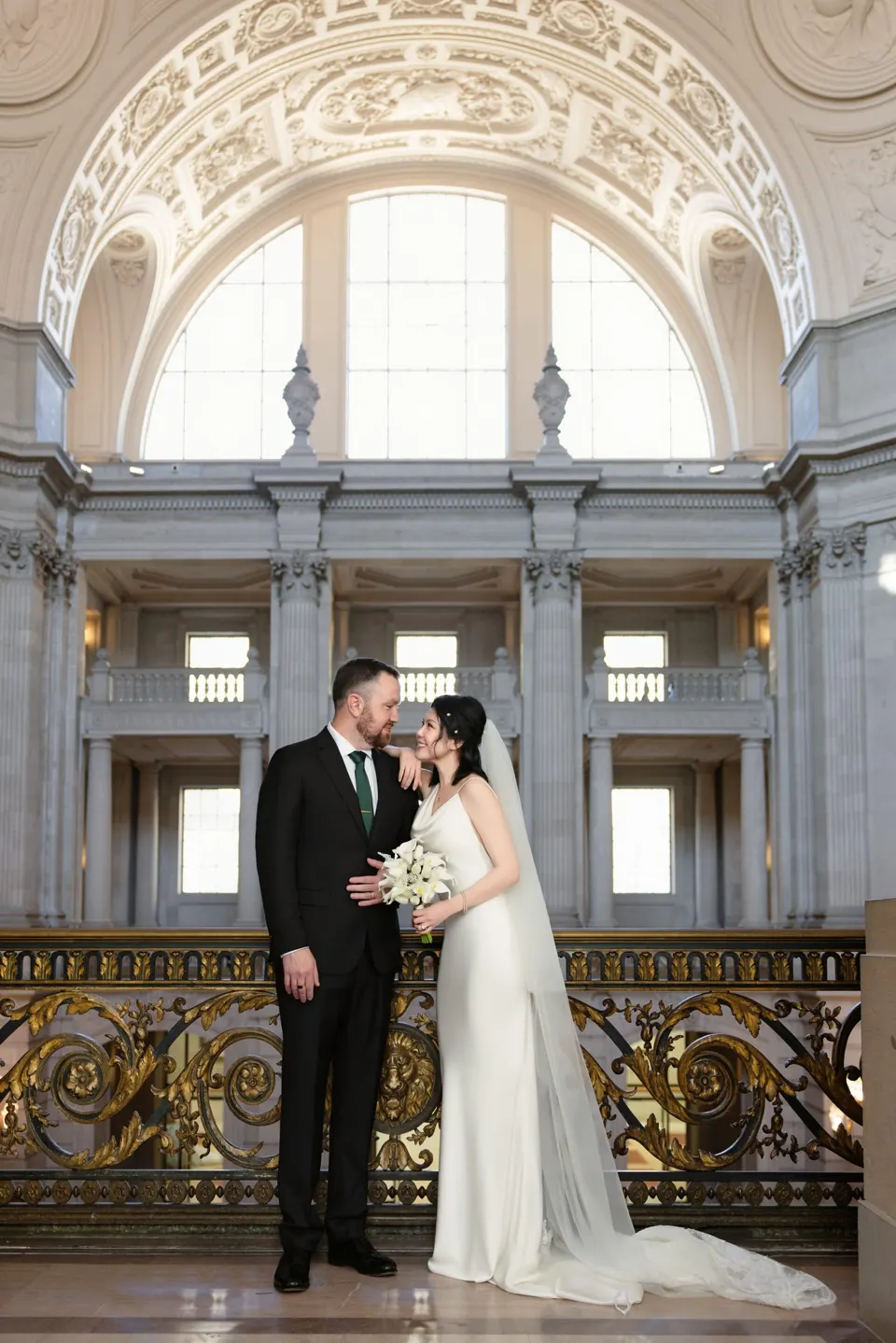 City Hall wedding with calla lilies and a long lace veil, frame 10 of 25