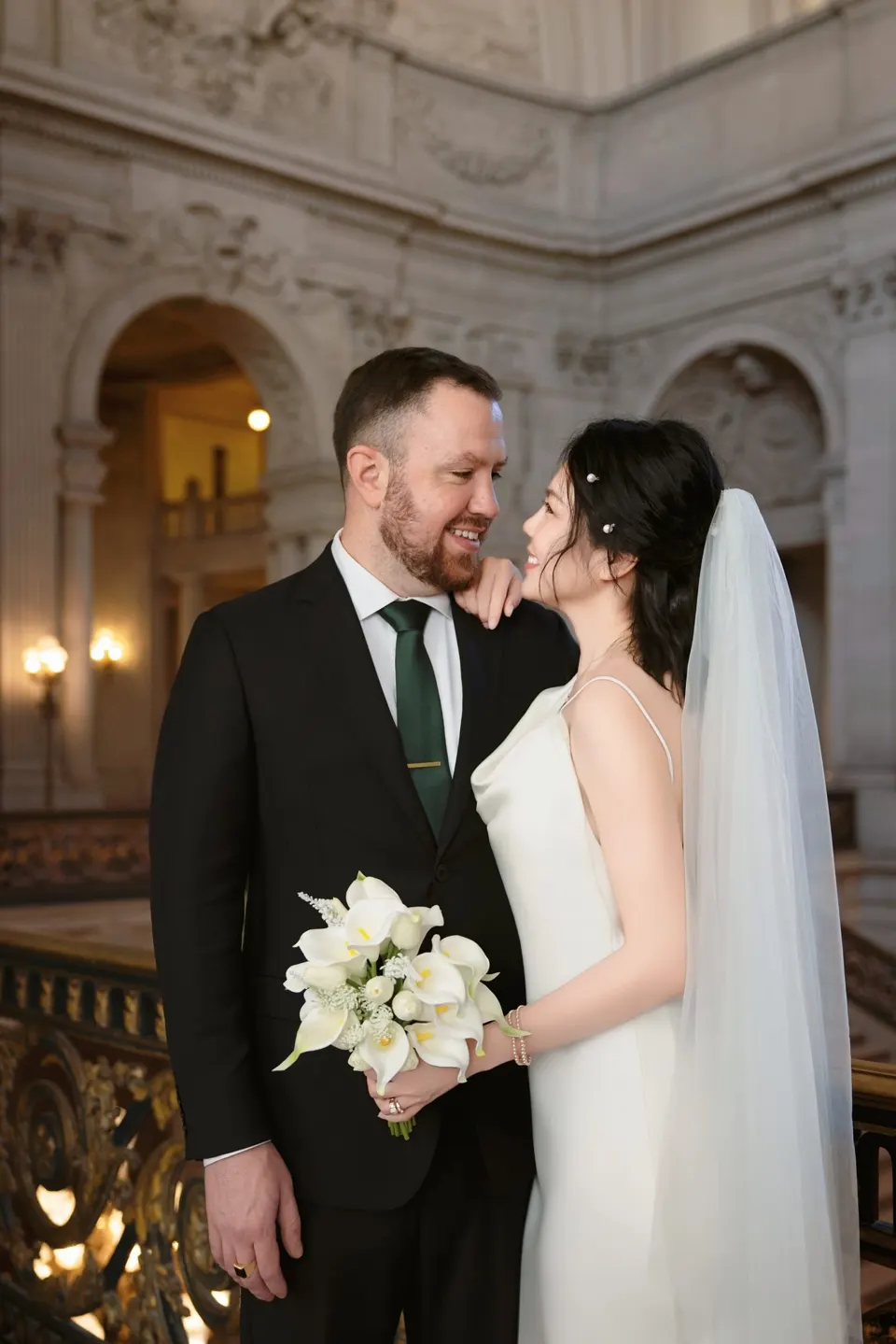 City Hall wedding with calla lilies and a long lace veil, frame 12 of 25