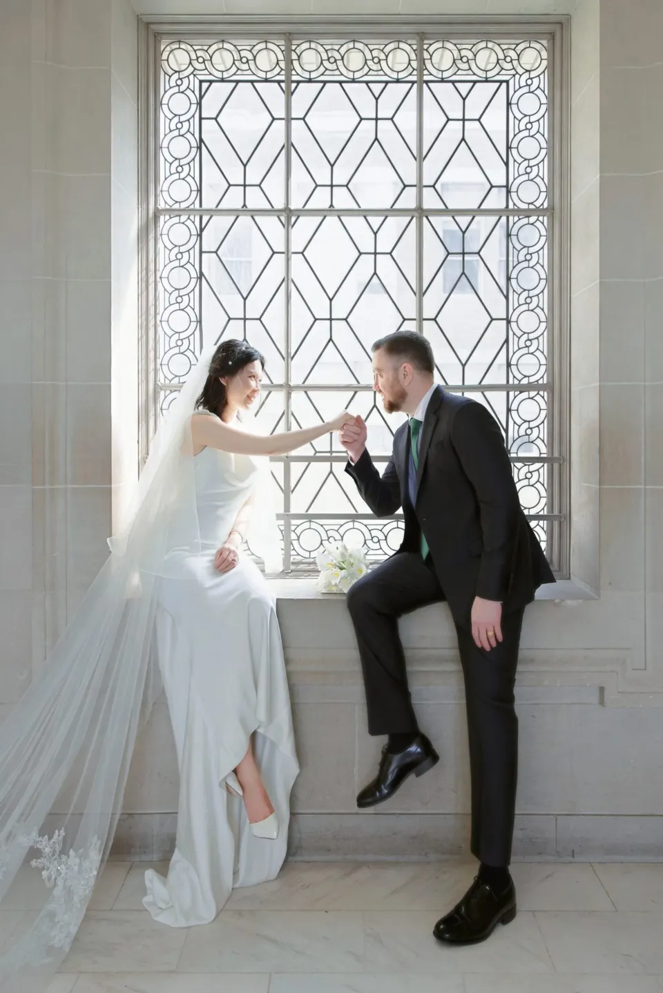 City Hall wedding with calla lilies and a long lace veil, frame 14 of 25