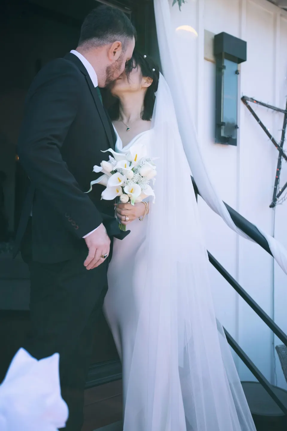 City Hall wedding with calla lilies and a long lace veil, frame 20 of 25