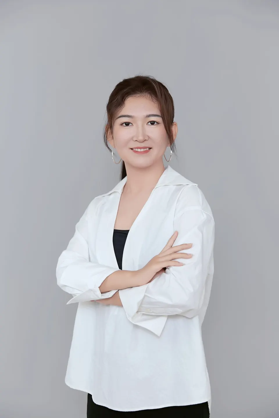 Studio headshot in a navy dress, frame 2 of 9