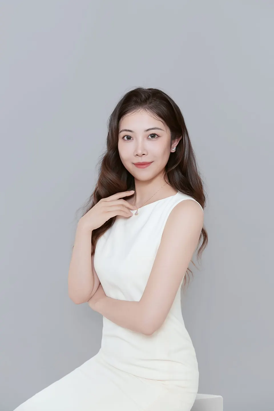Studio headshot in a navy dress, frame 8 of 9
