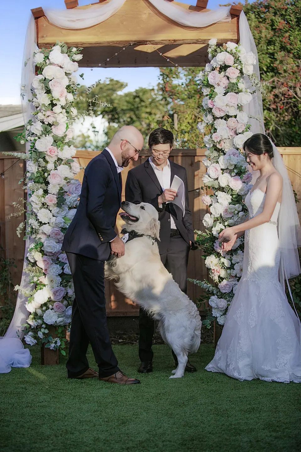 Garden wedding ceremony under a flower arch, frame 3 of 6
