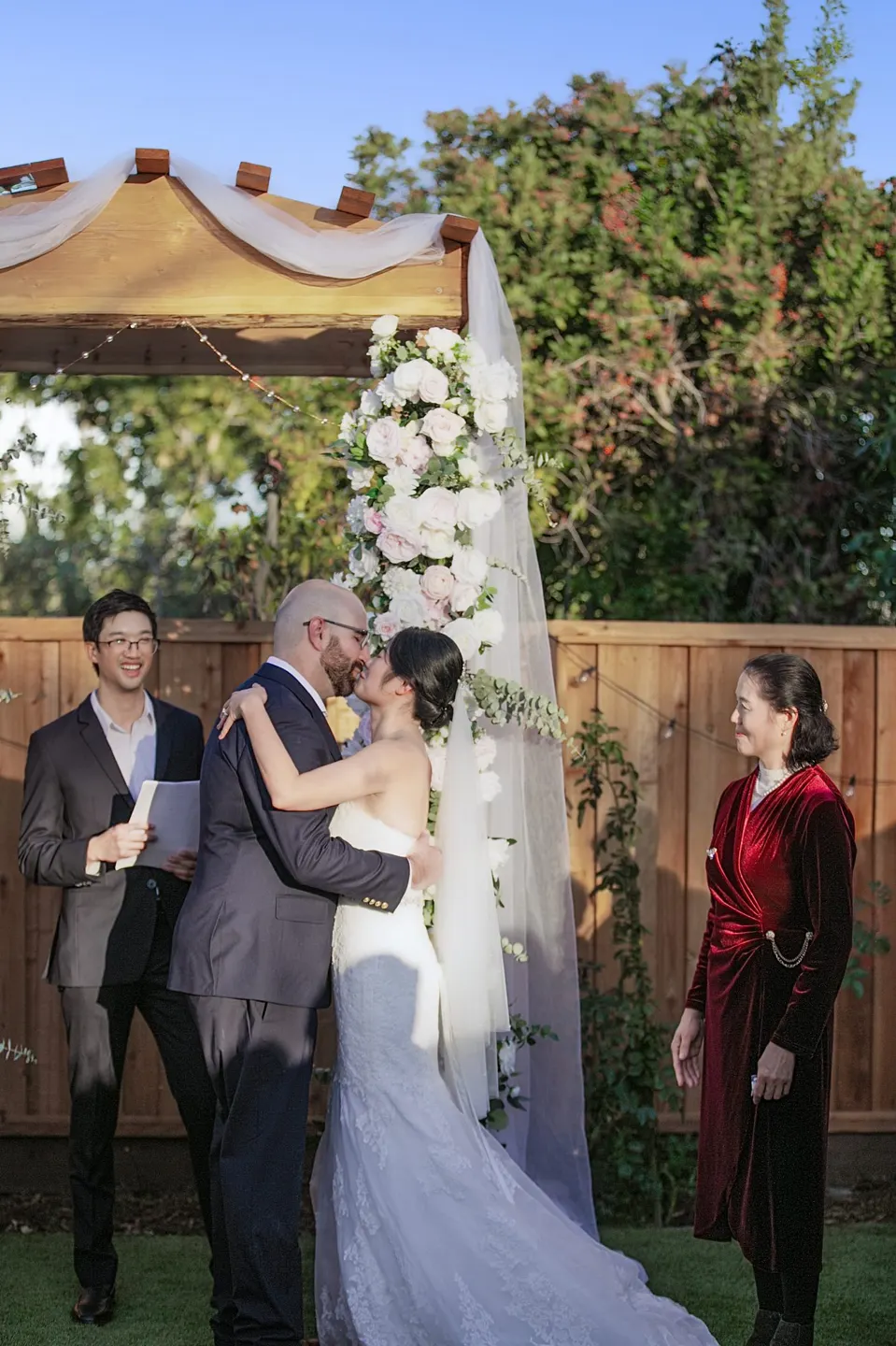 Garden wedding ceremony under a flower arch, frame 4 of 6
