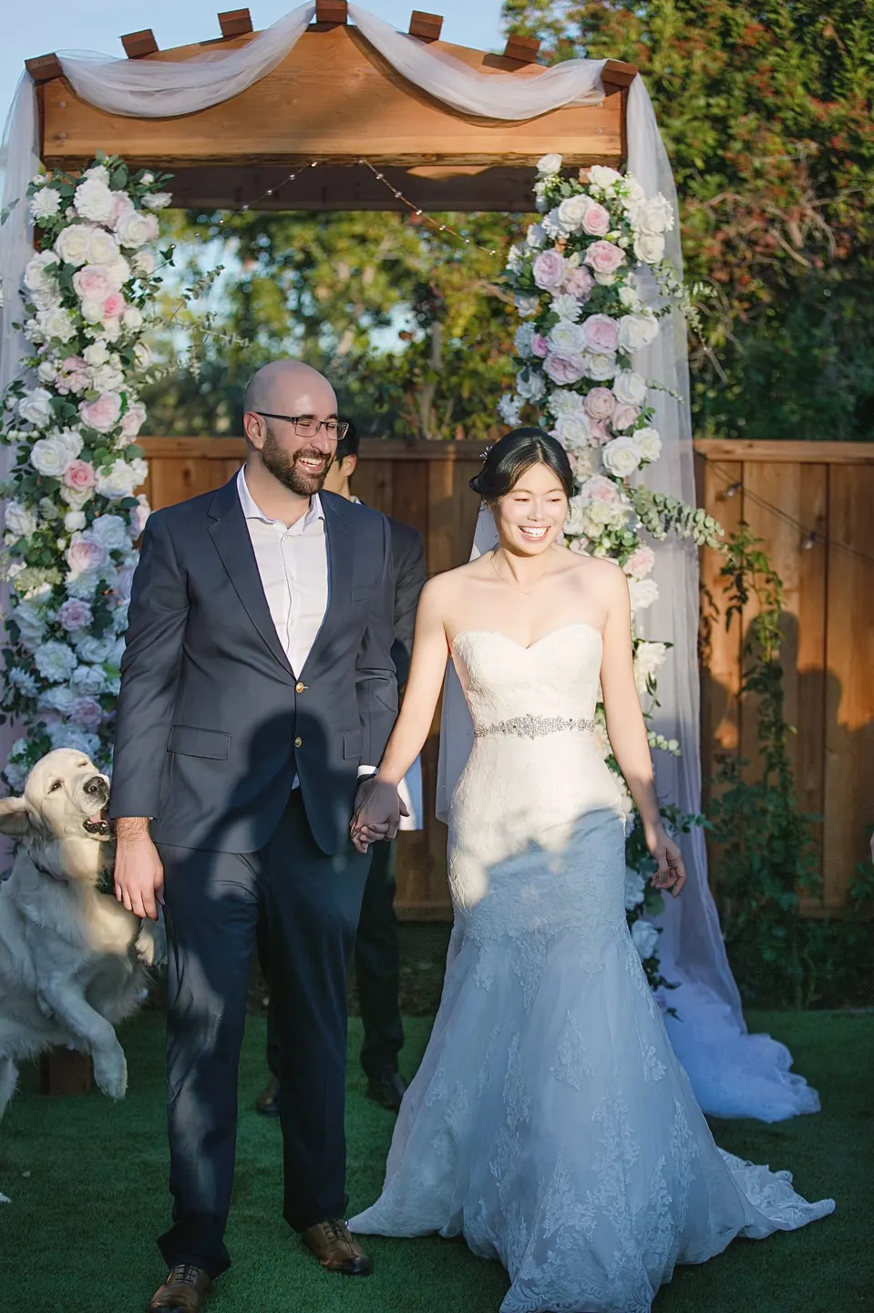 Garden wedding ceremony under a flower arch, frame 5 of 6