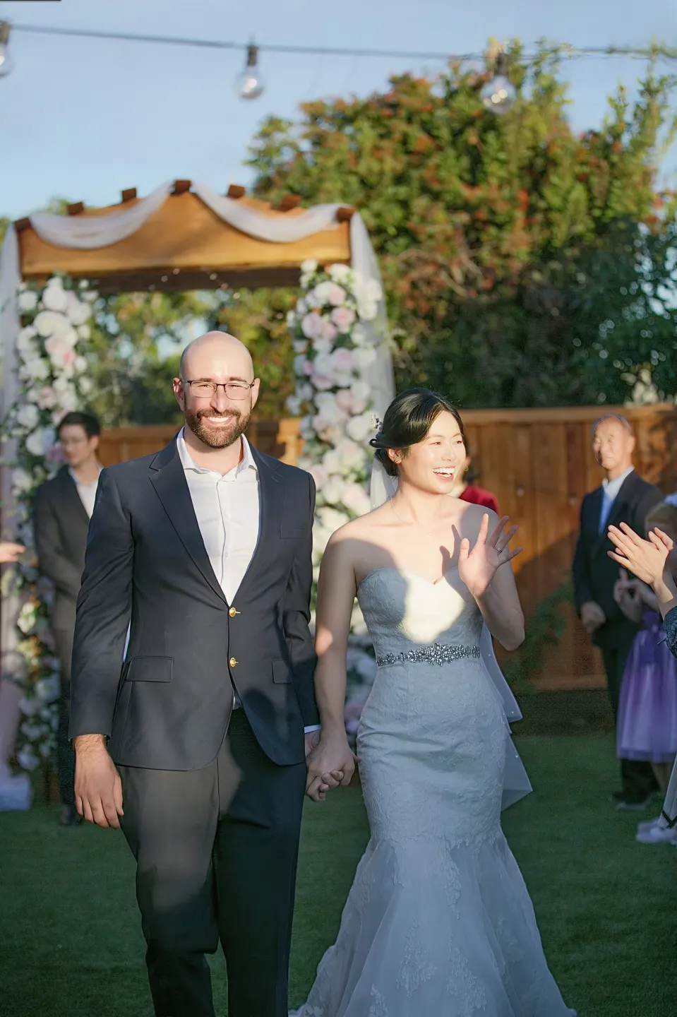 Garden wedding ceremony under a flower arch, frame 6 of 6