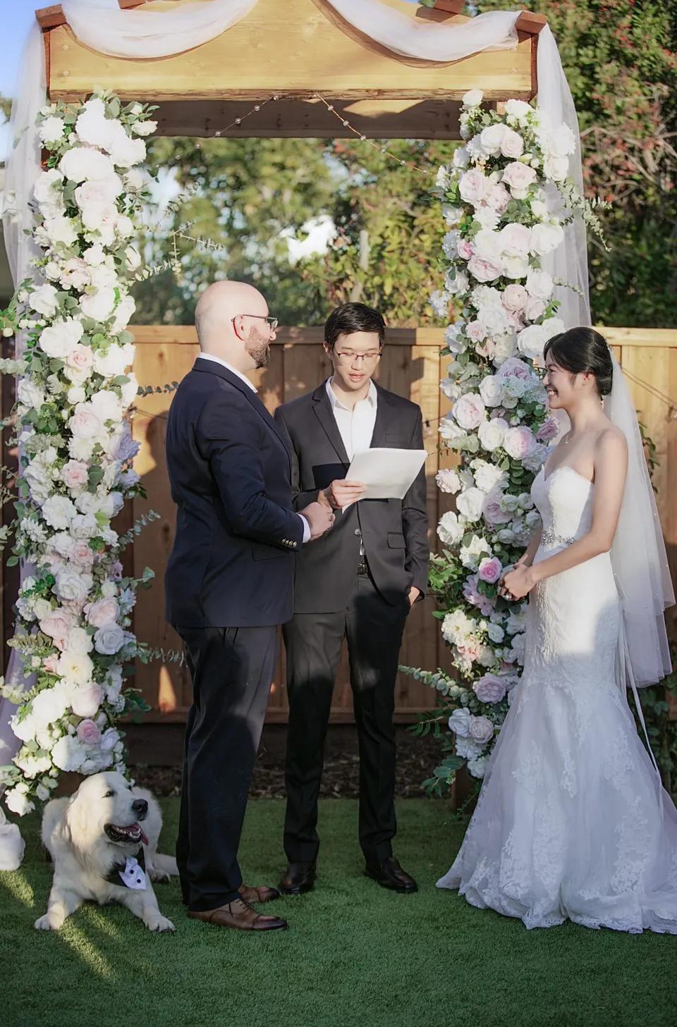 Garden wedding ceremony under a flower arch, frame 2 of 6